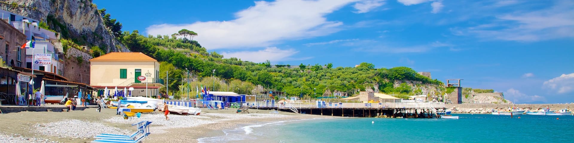 Marina di Puolo featuring a bay or harbor, a pebble beach and a coastal town