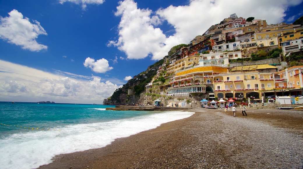 Positano which includes a beach and a coastal town