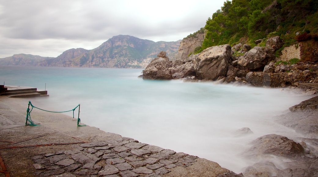 Praiano which includes mist or fog and rugged coastline