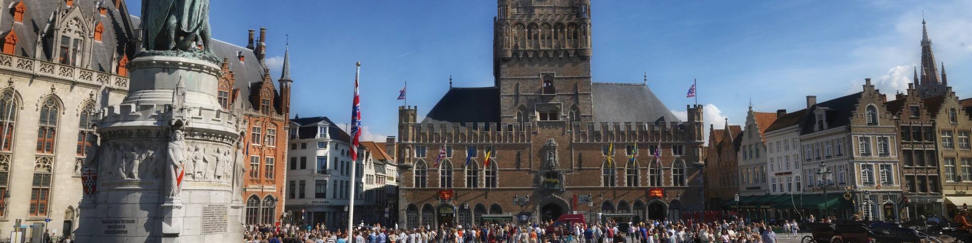 Bruges Belfry showing a city and heritage architecture as well as a large group of people