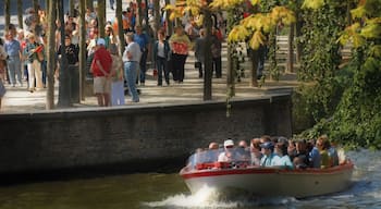 Bruges showing boating and a river or creek as well as a large group of people