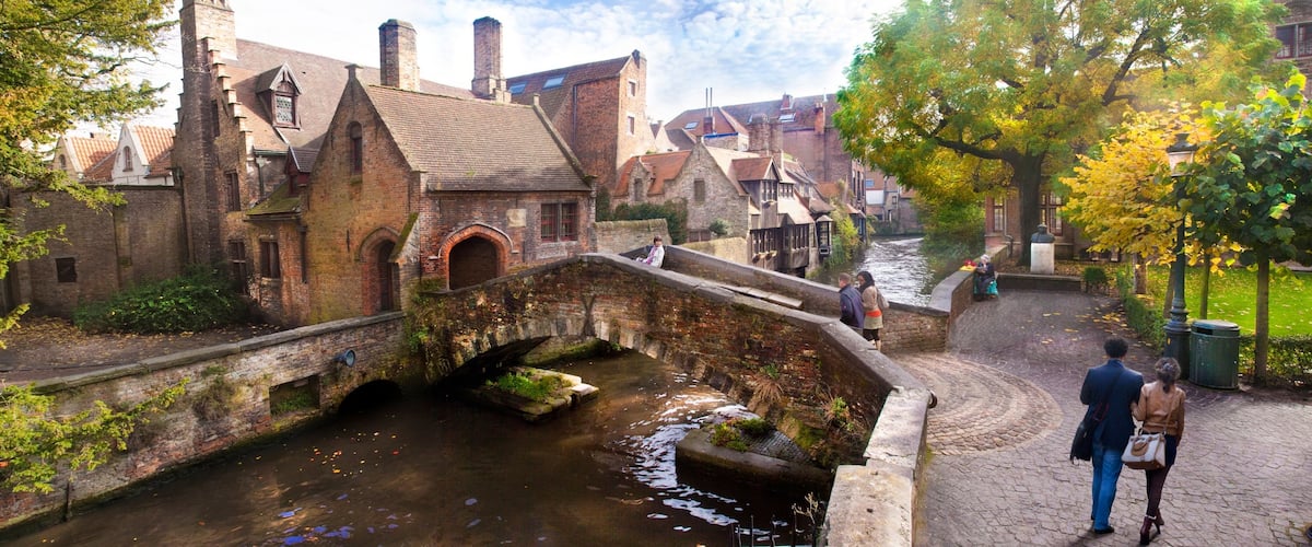 Bruges which includes street scenes, a river or creek and a house
