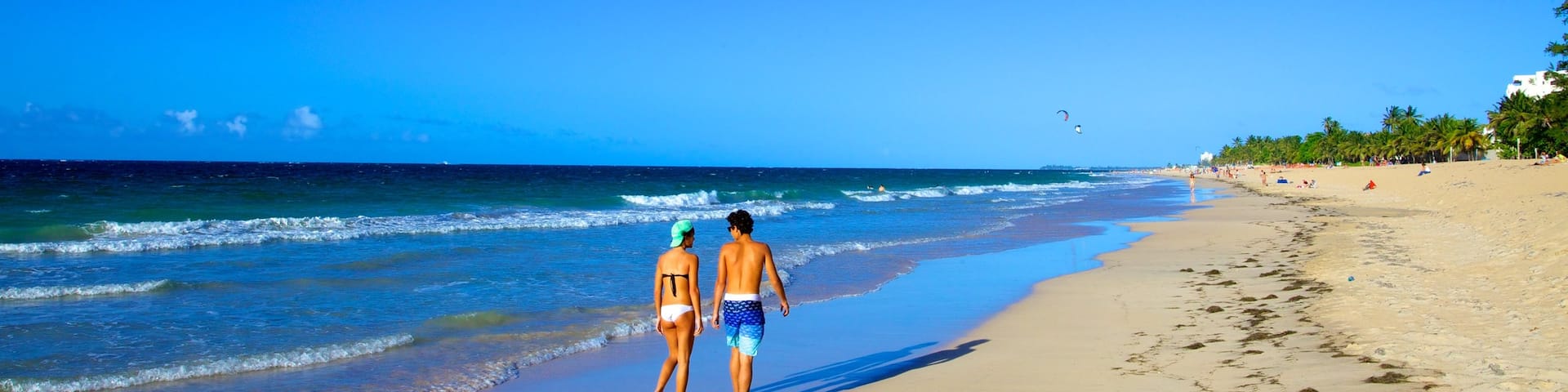 San Juan showing a beach as well as a couple