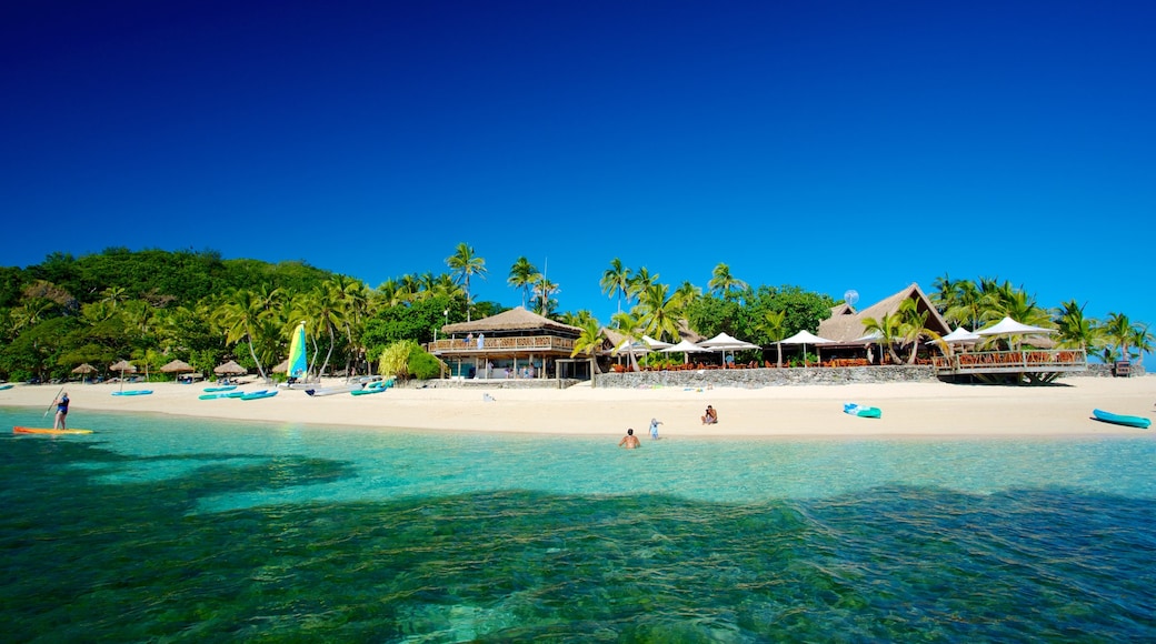 Castaway Island featuring a luxury hotel or resort, tropical scenes and a sandy beach