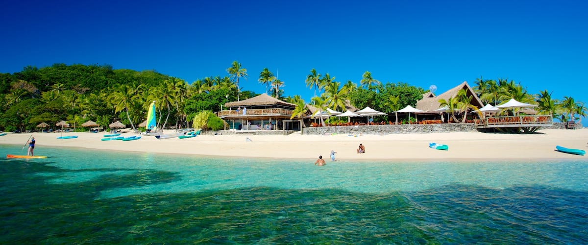 Castaway Island featuring a luxury hotel or resort, tropical scenes and a sandy beach