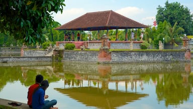 Mataram showing a pond and a temple or place of worship as well as a couple