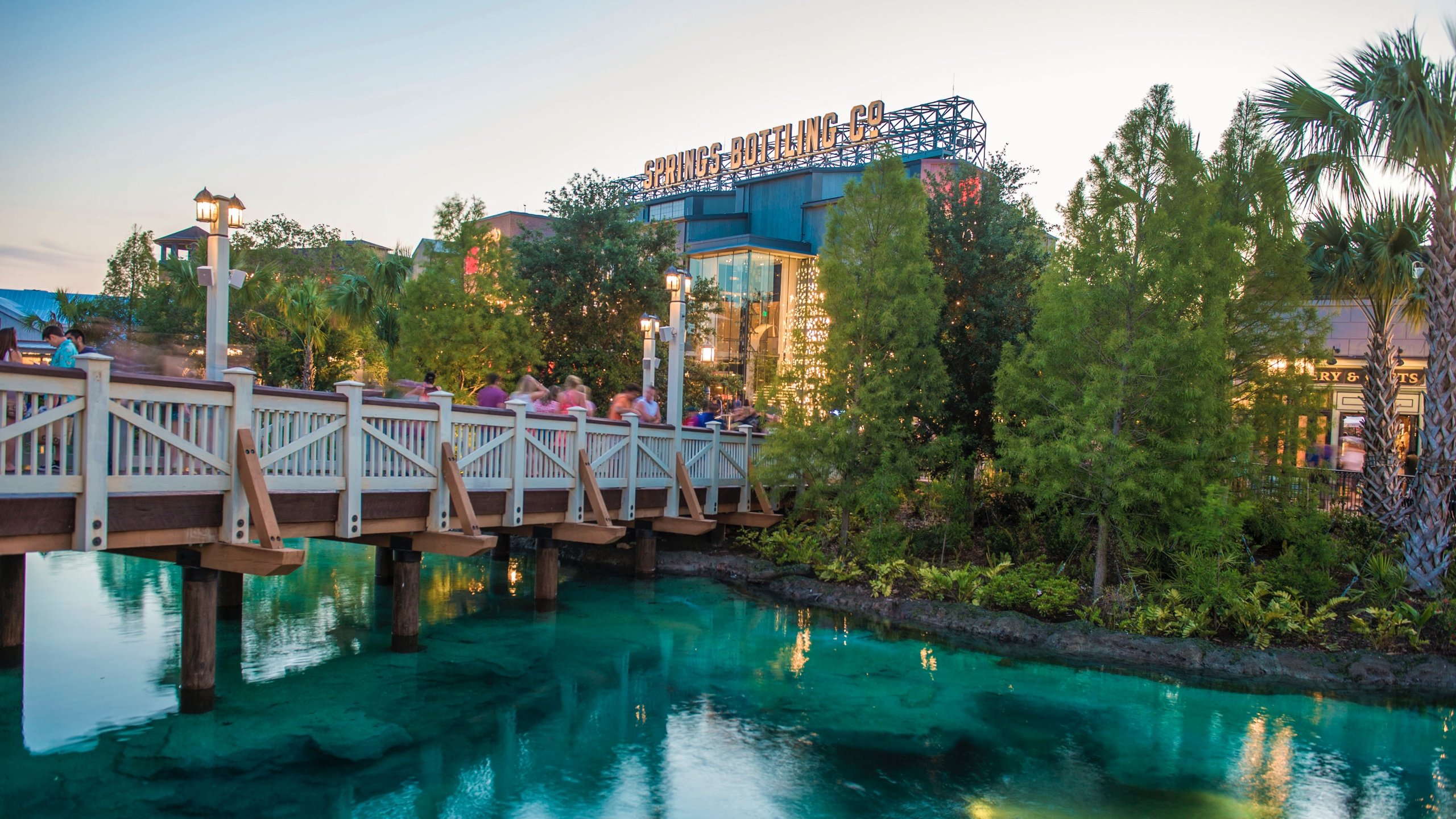 Disney Springs® showing a river or creek, a bridge and a sunset