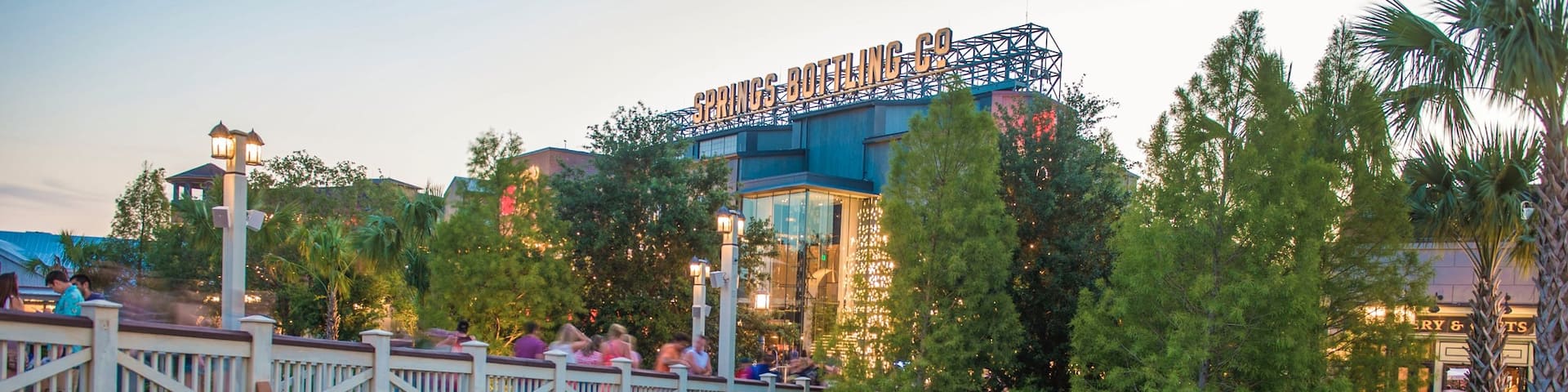 Disney Springs® showing a river or creek, a bridge and a sunset