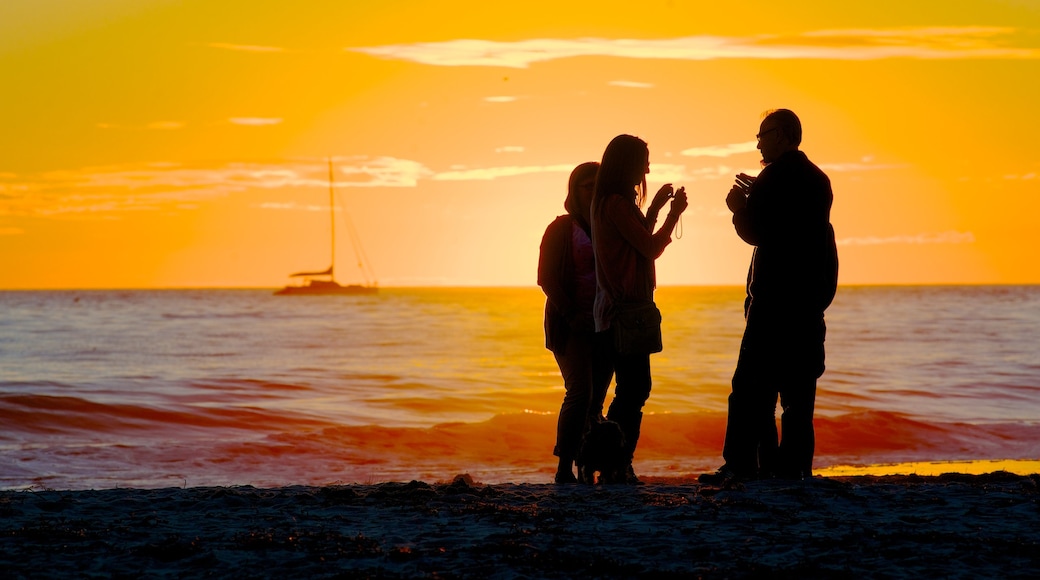 Glenelg Beach which includes a sunset, a pebble beach and landscape views