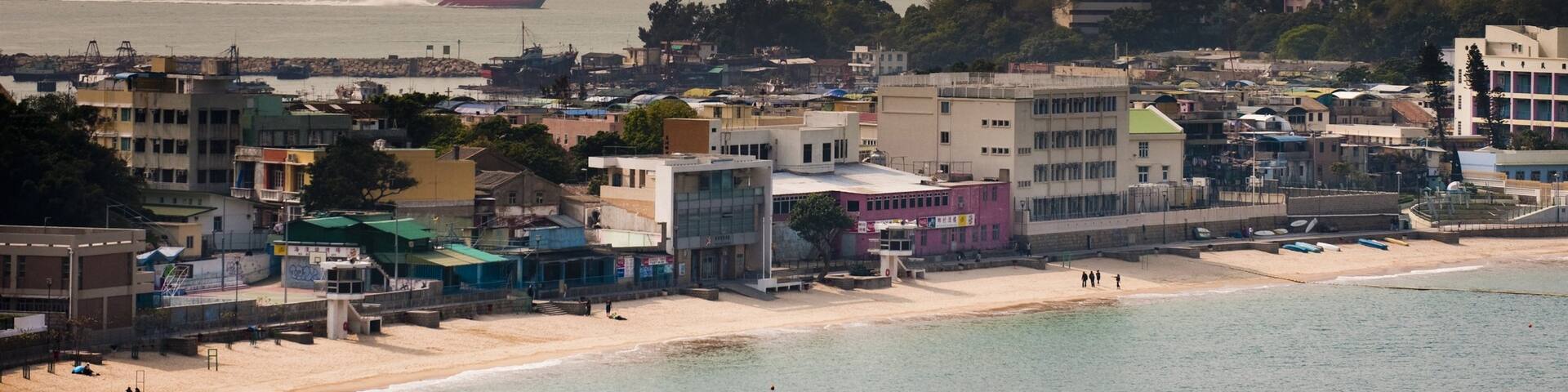 Cheung Chau which includes a sunset, a beach and a coastal town