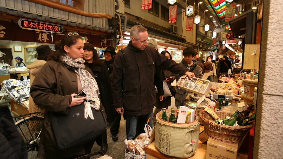 Nishiki Market featuring markets and street scenes as well as a large group of people