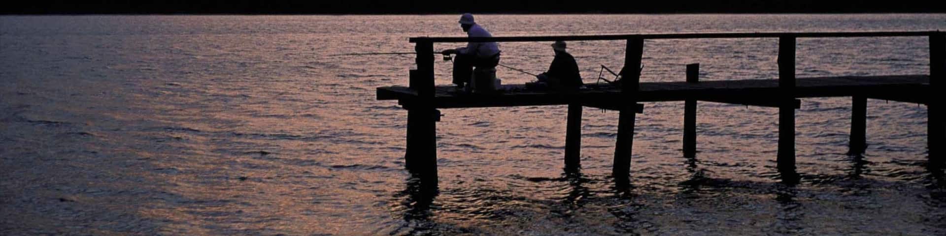 St. Lucia Wetland Heritage Park and Estuary featuring a lake or waterhole, a sunset and fishing