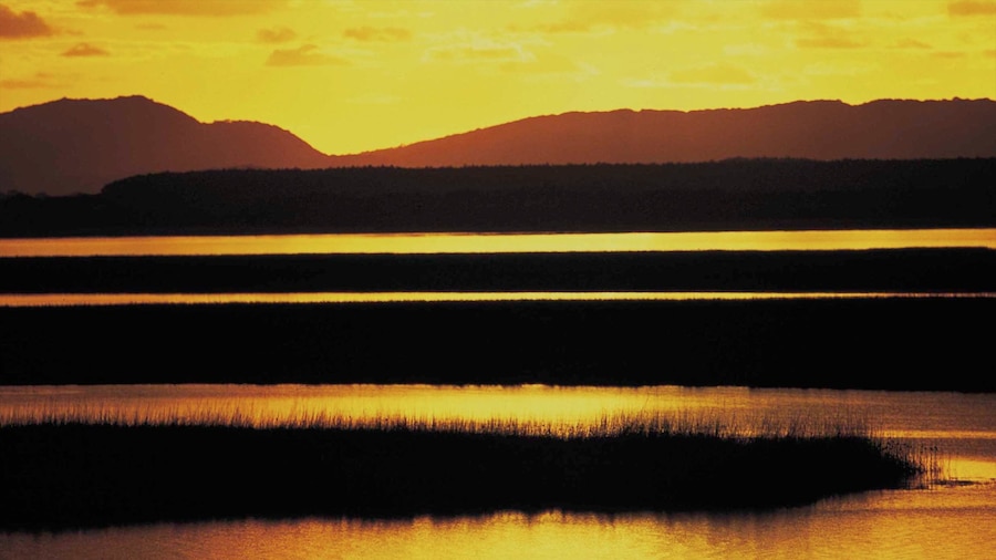 Greater St Lucia Wetland Park which includes mountains, a sunset and wetlands