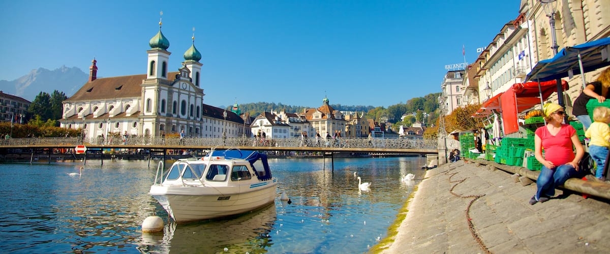 Old Town Lucerne showing boating, heritage architecture and a church or cathedral