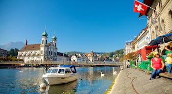 Old Town Lucerne showing boating, heritage architecture and a church or cathedral