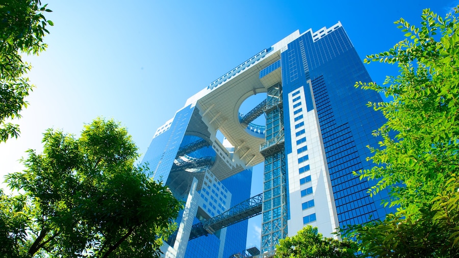 Umeda Sky Building with futuristic architecture and lush greenery in Osaka, Japan.