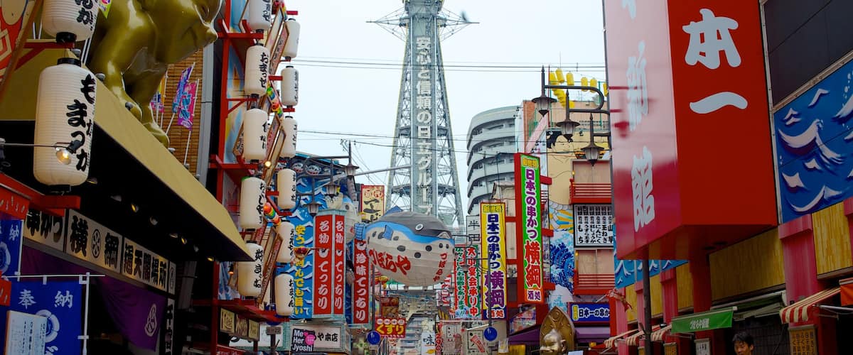 Tsutenkaku Tower featuring street scenes, a skyscraper and a city
