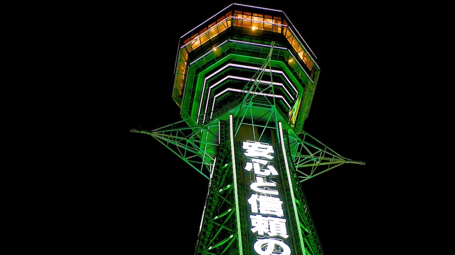 Tsutenkaku Tower which includes night scenes, signage and modern architecture