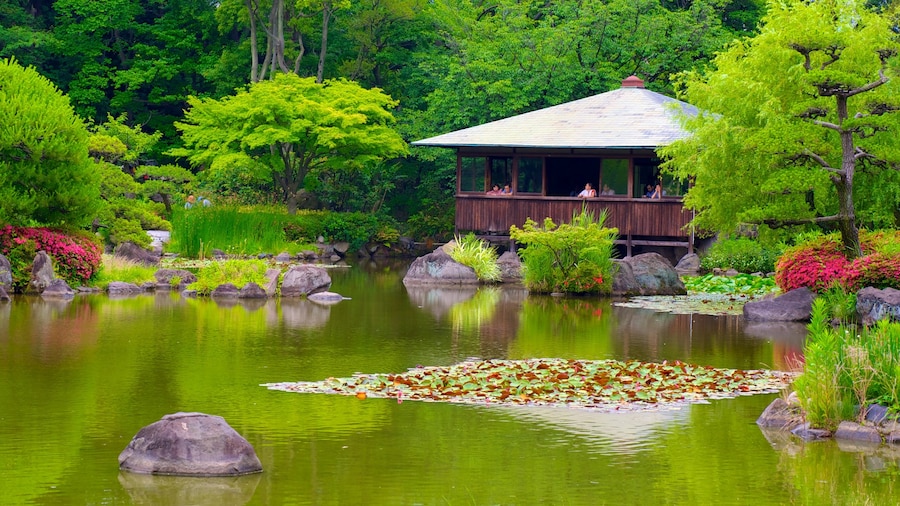 Tennoji Park with lush gardens and a tranquil pond in Osaka, Japan.