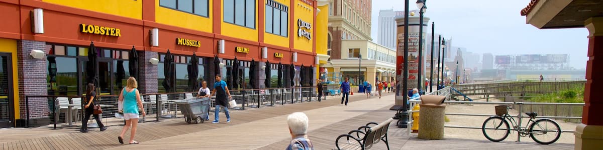 Atlantic City Boardwalk showing a coastal town and street scenes as well as an individual female
