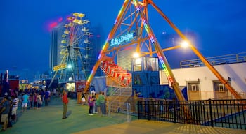 Boardwalk Hall featuring night scenes, rides and a city