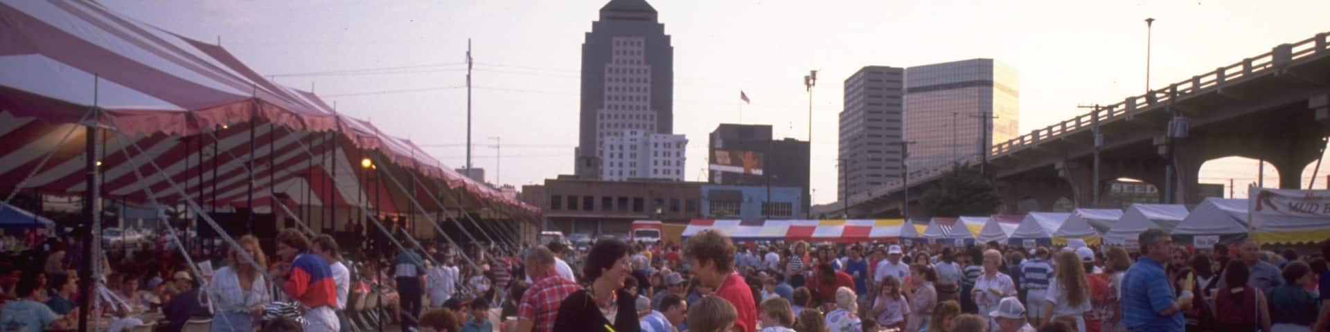 Shreveport Festival Plaza featuring a sunset and outdoor eating as well as a large group of people