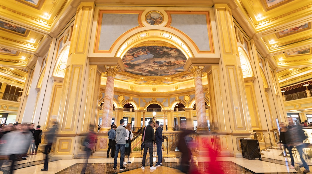 Venetian Macao Casino featuring heritage elements and interior views as well as a small group of people