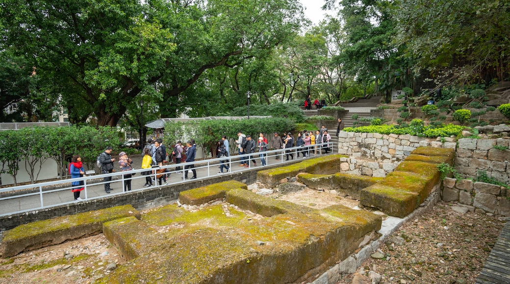 Ruins of St. Paul\'s Cathedral which includes a garden and building ruins as well as a small group of people