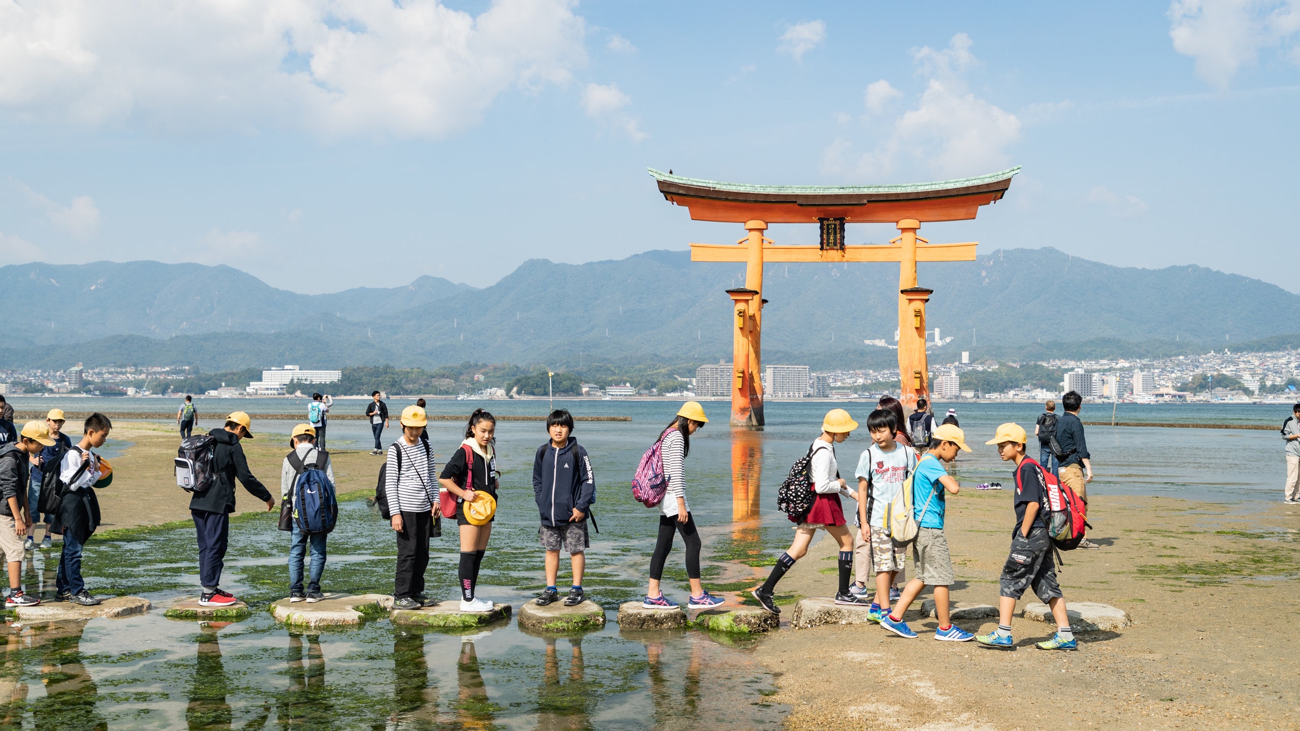 Itsukushima Shrine showing heritage elements and a river or creek as well as children