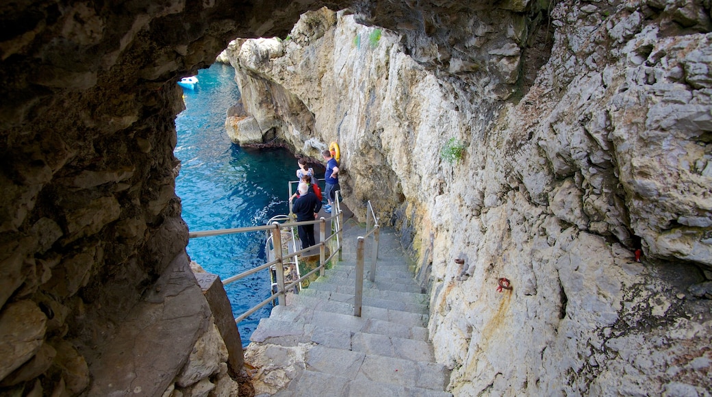 Blue Grotto showing hiking or walking and rocky coastline