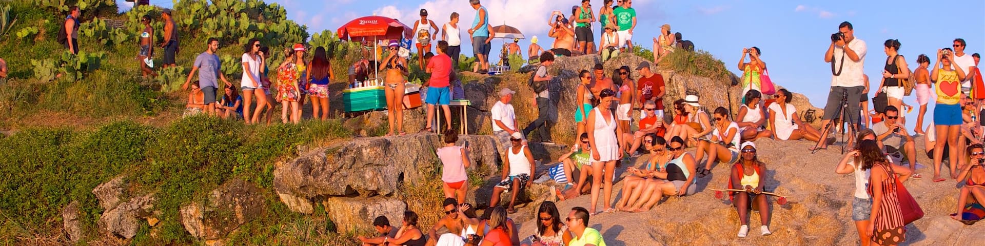 Zona Sul featuring rugged coastline, a sunset and general coastal views