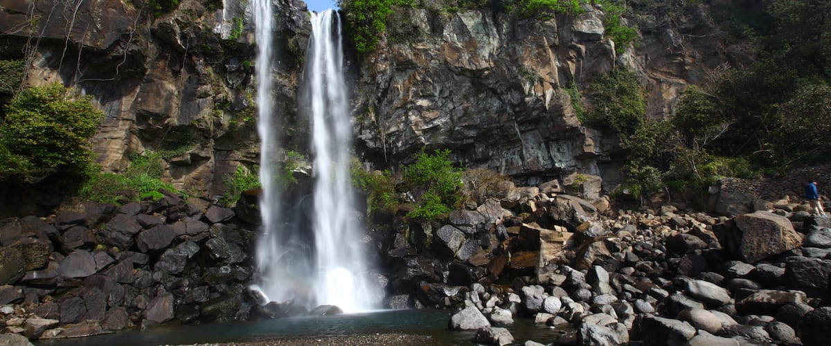 Jeongbang Waterfall featuring a gorge or canyon and a waterfall