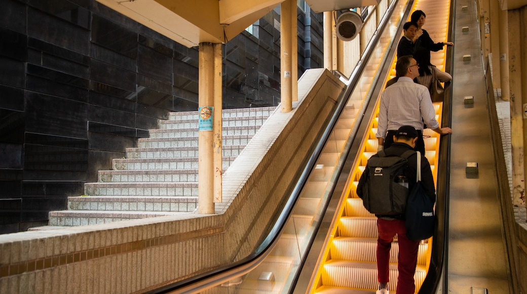 Mid-levels Escalators featuring interior views as well as a small group of people