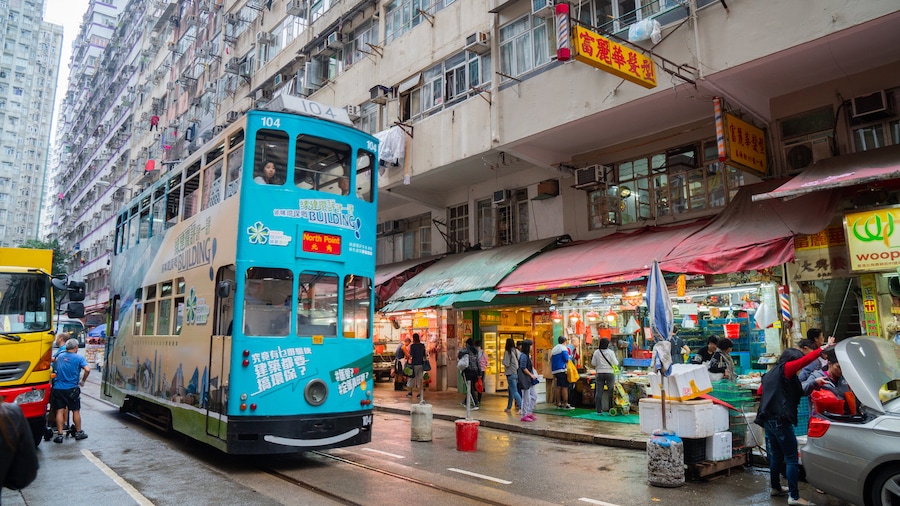 Chun Yeung Street Market showing a city, street scenes and railway items