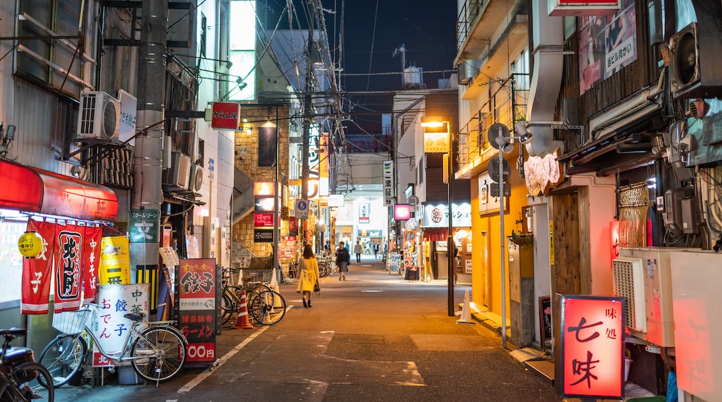 Matsuyama featuring night scenes and a city