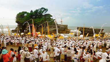 Tanah Lot which includes general coastal views as well as a large group of people