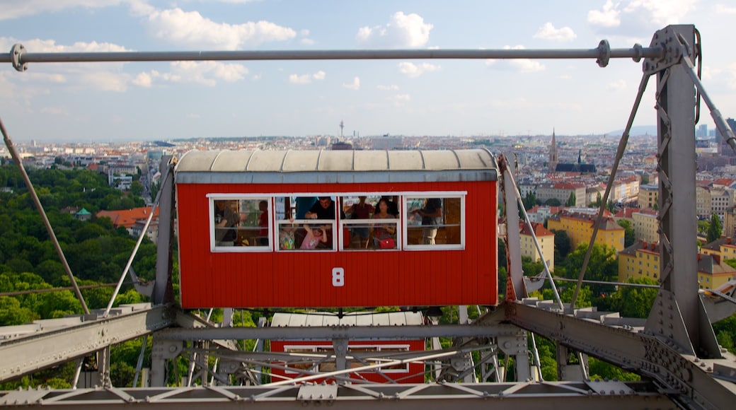 Wiener Prater showing rides and a city as well as a family