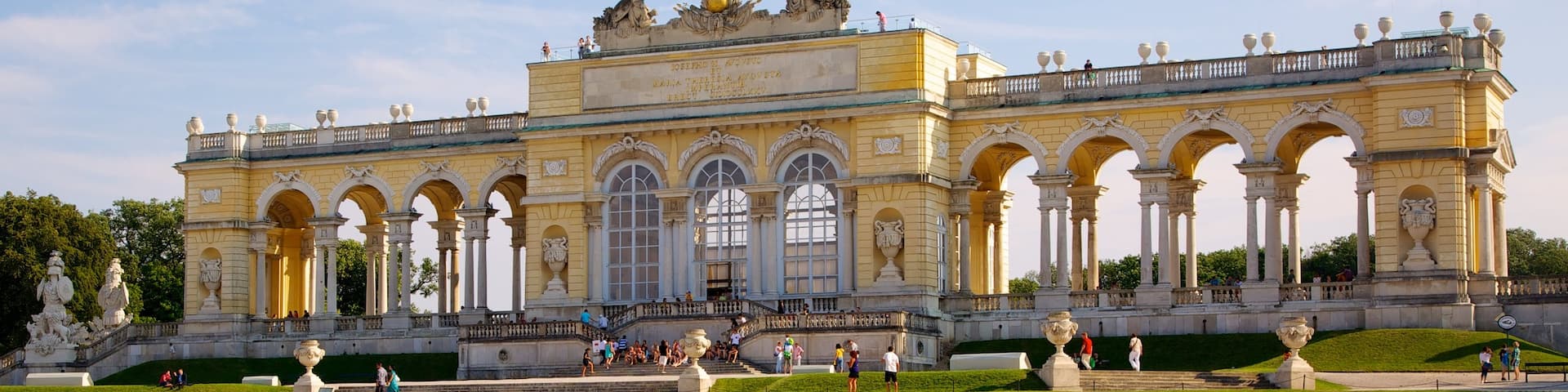 Schoenbrunn Palace which includes a castle, a pond and a garden