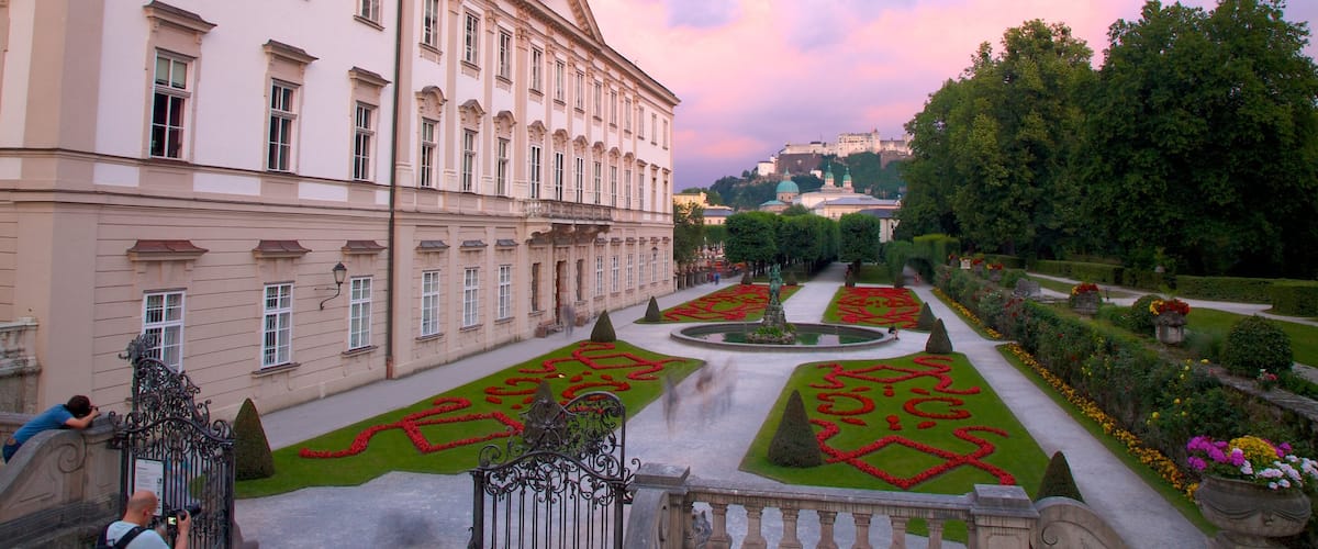 Palacio de Mirabell y jardines que incluye patrimonio de arquitectura, una puesta de sol y castillo o palacio