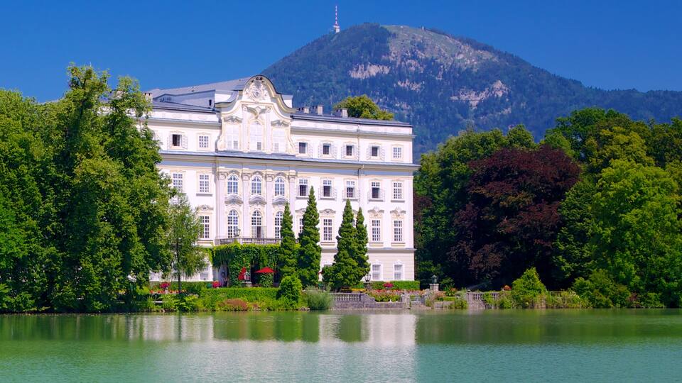 Leopoldskron Palace which includes heritage architecture, a castle and a lake or waterhole