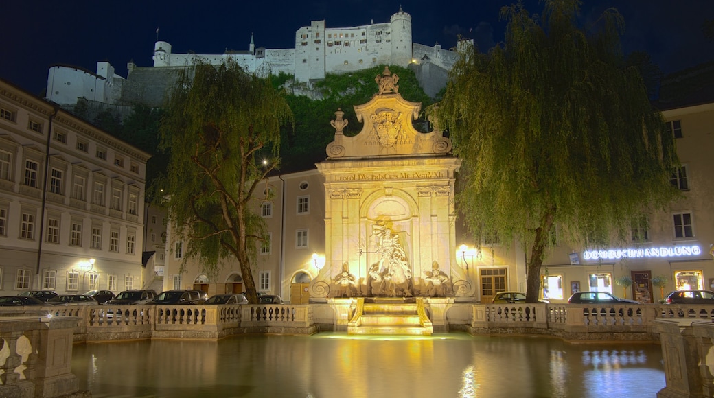 Salzburg featuring a pond, heritage architecture and night scenes