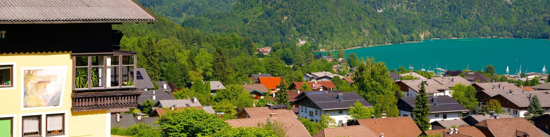 St. Gilgen showing a lake or waterhole, mountains and a small town or village