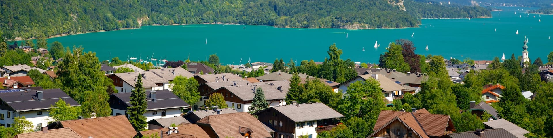 St. Gilgen which includes a lake or waterhole, mountains and a small town or village
