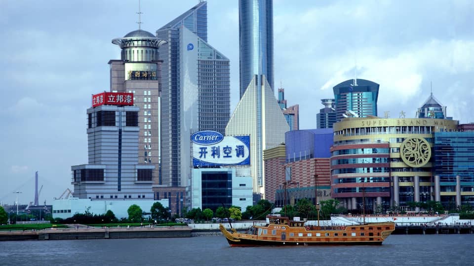 Shanghai which includes a city, a river or creek and signage
