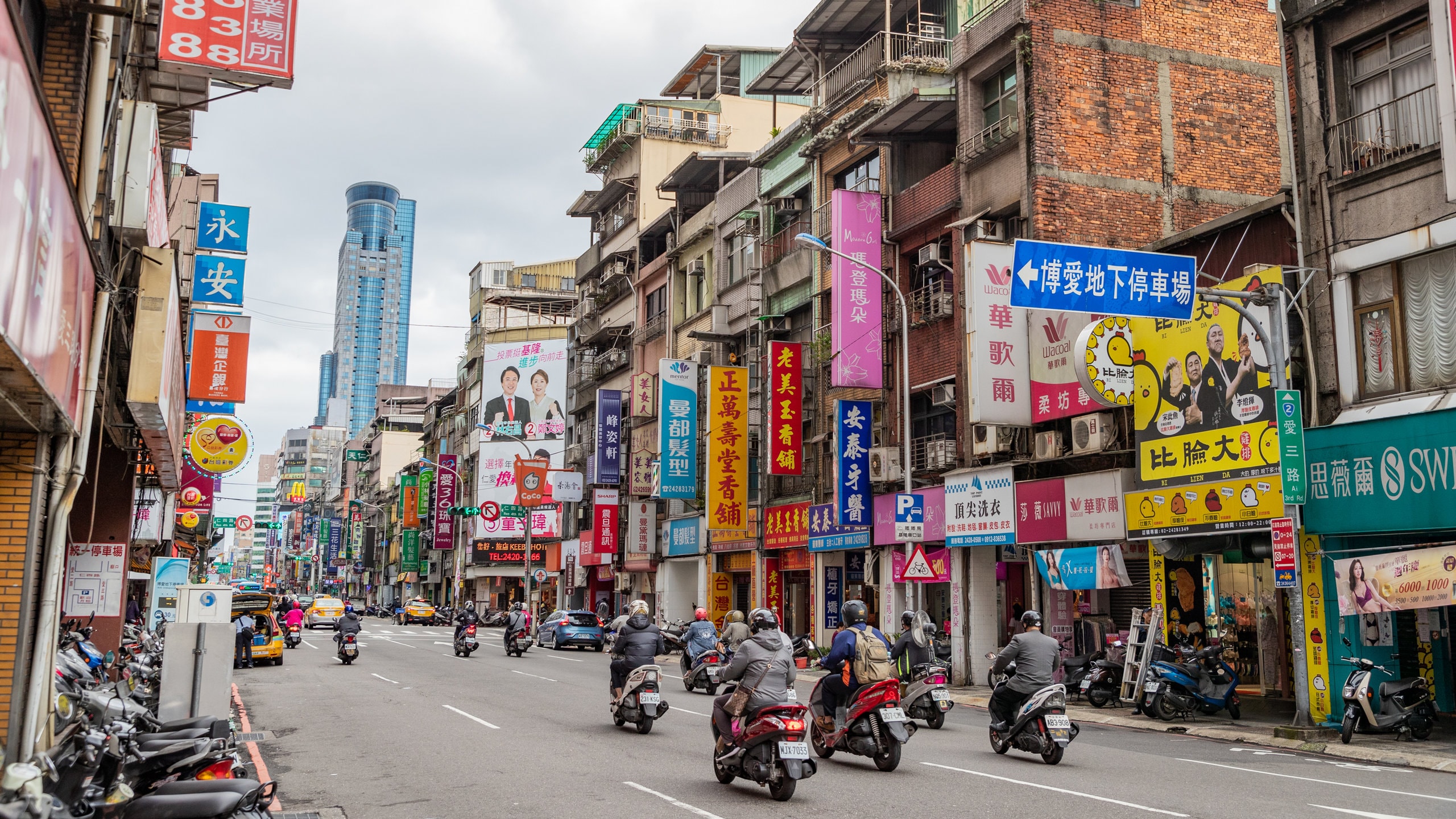 Keelung City Centre showing a city, motorcycle riding and street scenes