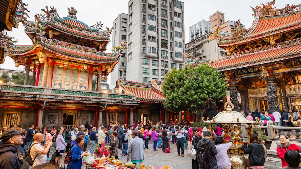 Lungshan Temple which includes heritage elements and street scenes as well as a large group of people