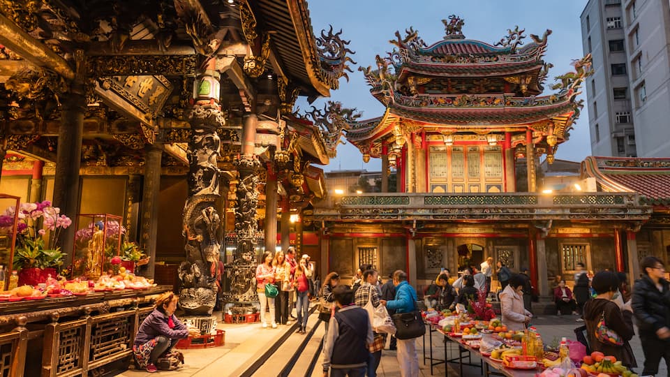 Lungshan Temple which includes a temple or place of worship, street scenes and heritage architecture