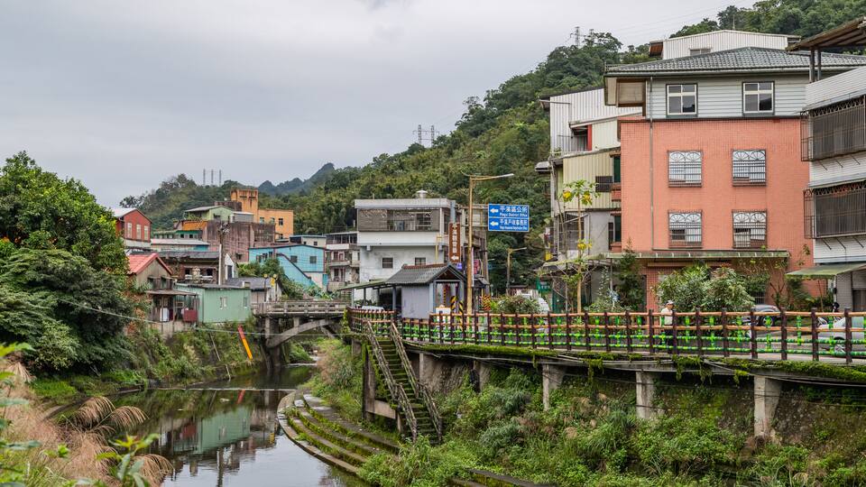 Pingxi District which includes a river or creek and a small town or village