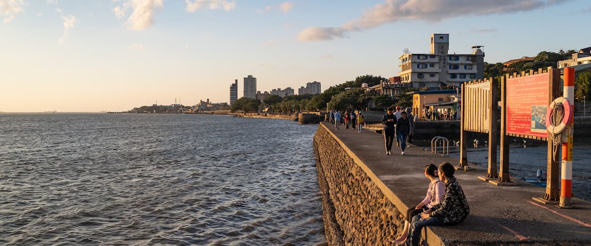 Tamsui showing a sunset, a coastal town and general coastal views