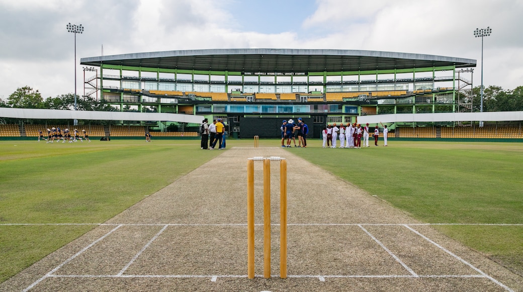 Rangiri Dambulla International Stadium showing a sporting event as well as a small group of people